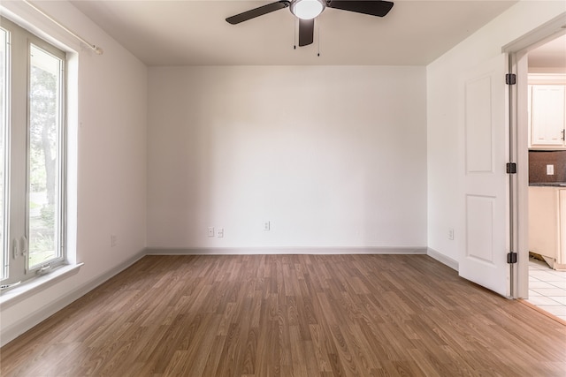 empty room with hardwood / wood-style flooring and ceiling fan