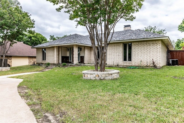 view of front facade with central AC unit and a front yard