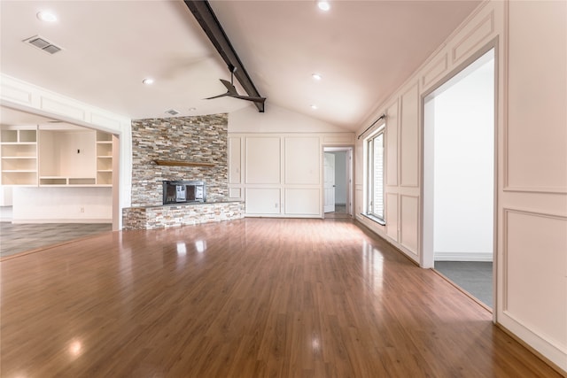 unfurnished living room with high vaulted ceiling, a stone fireplace, ceiling fan, wood-type flooring, and beamed ceiling