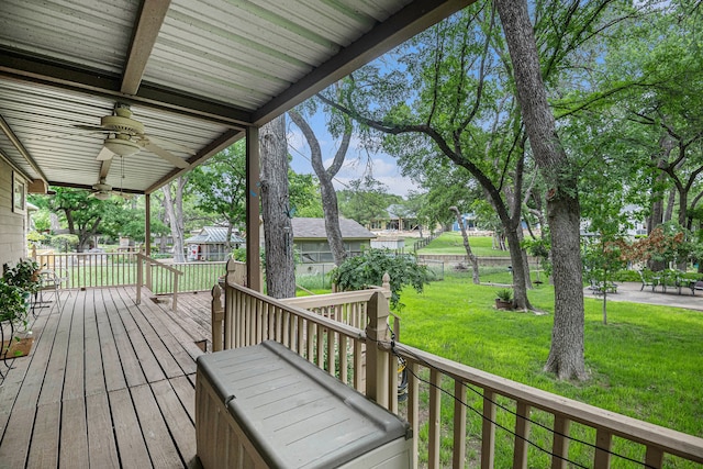 deck with a yard and ceiling fan