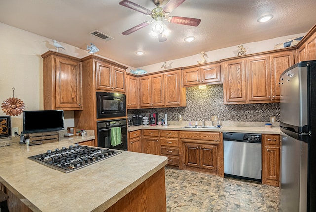 kitchen with black appliances, kitchen peninsula, tasteful backsplash, light tile flooring, and ceiling fan