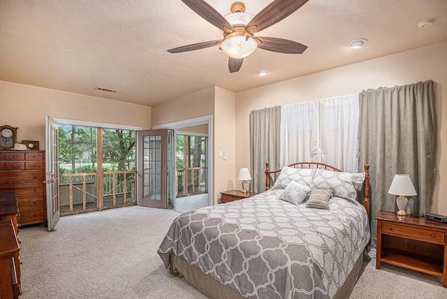 bedroom with a textured ceiling, carpet, ceiling fan, and access to exterior