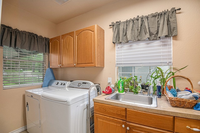 laundry room with separate washer and dryer, sink, and cabinets