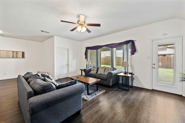 living room featuring dark hardwood / wood-style flooring, ceiling fan, and a healthy amount of sunlight