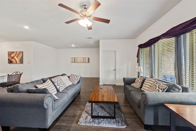 living room with ceiling fan and dark hardwood / wood-style floors