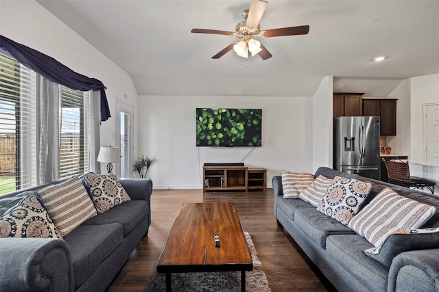 living room with dark hardwood / wood-style flooring and ceiling fan