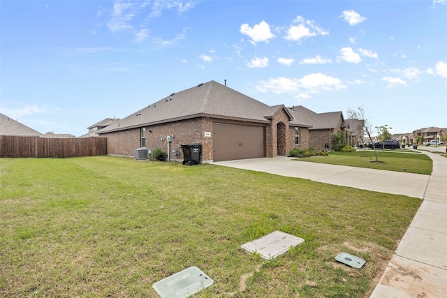 view of front facade featuring a garage, central AC, and a front lawn