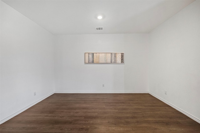 spare room with dark hardwood / wood-style flooring