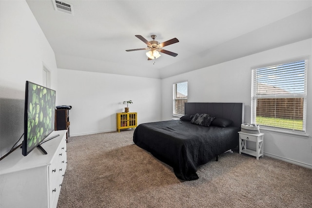 carpeted bedroom featuring ceiling fan and multiple windows