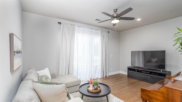 living room featuring ceiling fan and hardwood / wood-style flooring