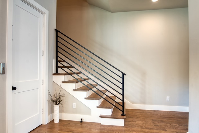 stairway featuring hardwood / wood-style flooring