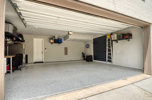 garage featuring a garage door opener, electric panel, and stainless steel fridge