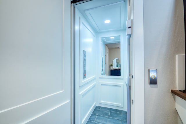 hallway with dark hardwood / wood-style floors and elevator