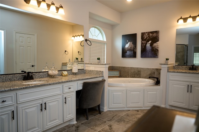 bathroom with vanity, tile floors, and a bathtub