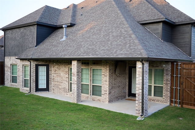 back of house featuring a lawn and a patio area