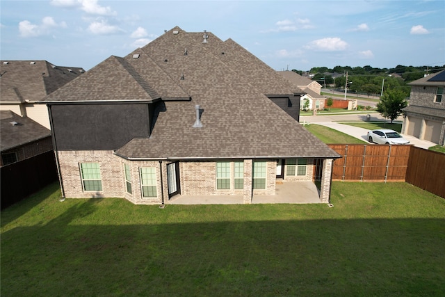 rear view of house with a yard