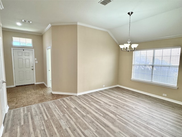 foyer with crown molding, plenty of natural light, light hardwood / wood-style floors, and a notable chandelier