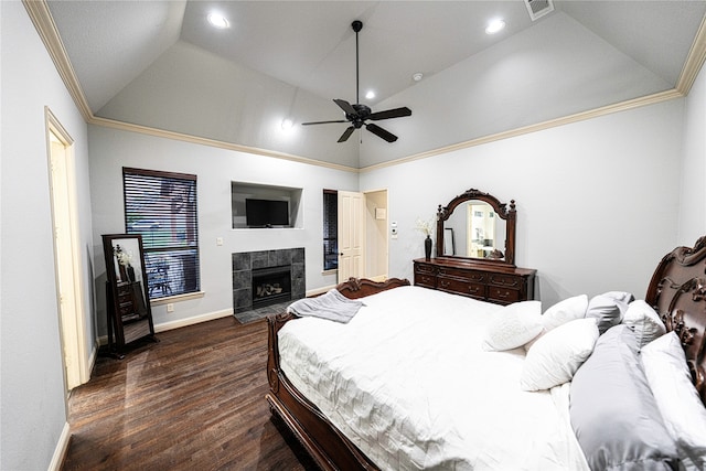 bedroom with a fireplace, crown molding, dark hardwood / wood-style flooring, ceiling fan, and lofted ceiling