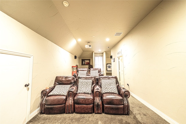 carpeted home theater featuring vaulted ceiling