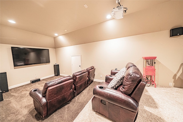 carpeted cinema room with lofted ceiling