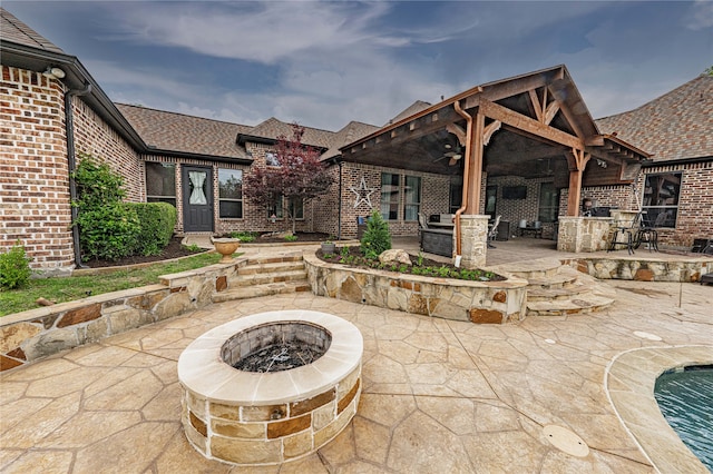 view of patio / terrace featuring an outdoor fire pit