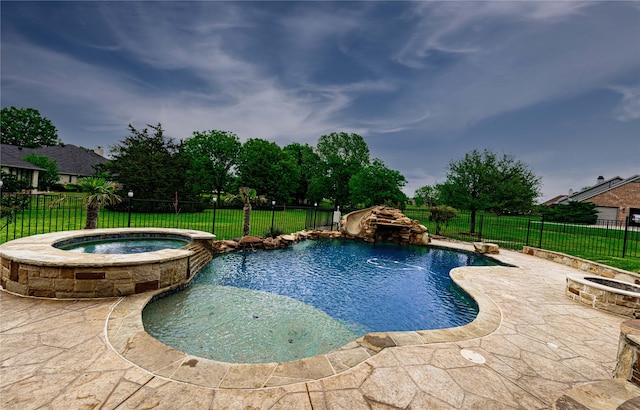 view of swimming pool with a patio, an in ground hot tub, and pool water feature