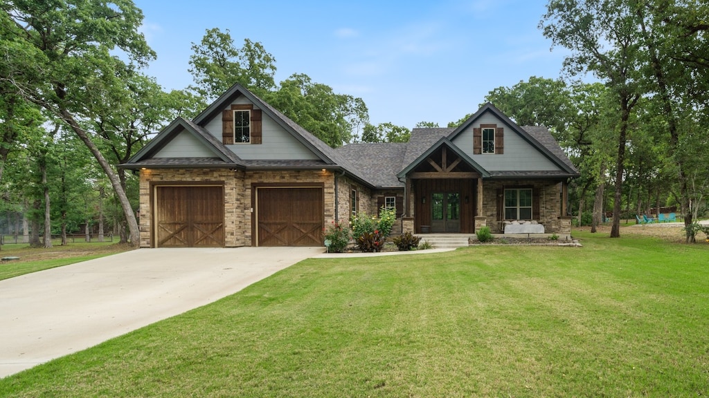 craftsman-style home with a front lawn and a garage