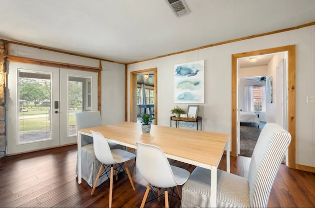 dining room featuring french doors, a healthy amount of sunlight, and dark hardwood / wood-style floors