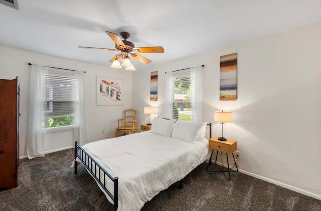 carpeted bedroom with multiple windows and ceiling fan