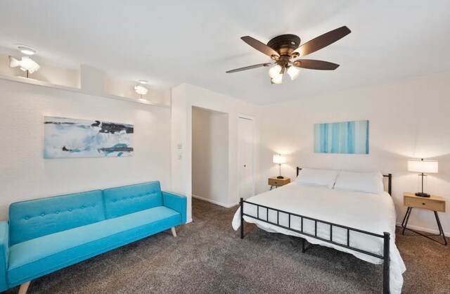 bedroom with a closet, ceiling fan, and dark carpet