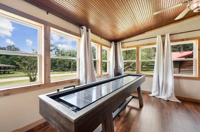 recreation room with a wealth of natural light, dark hardwood / wood-style flooring, and wood ceiling