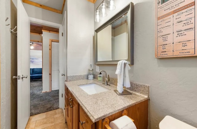 bathroom with ceiling fan, crown molding, toilet, tile flooring, and vanity