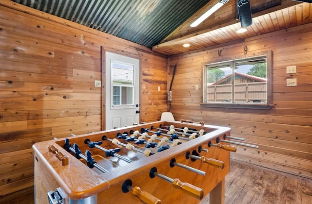 recreation room featuring wood-type flooring, wooden walls, vaulted ceiling, and wood ceiling