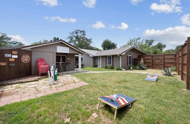 rear view of property with a lawn