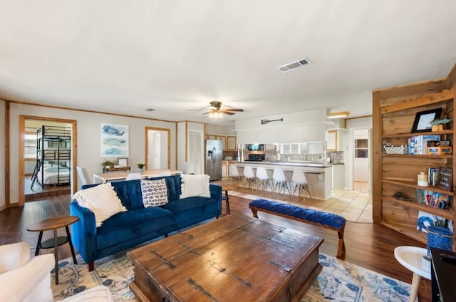 living room featuring light hardwood / wood-style flooring and ceiling fan