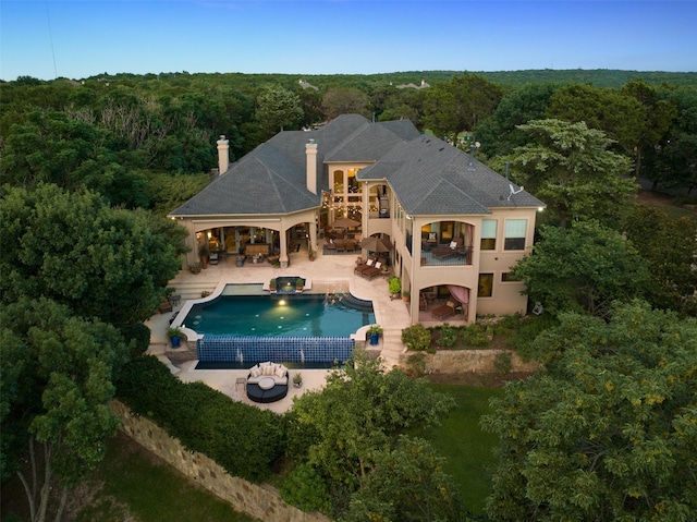 exterior space with an outdoor living space, a balcony, and a patio