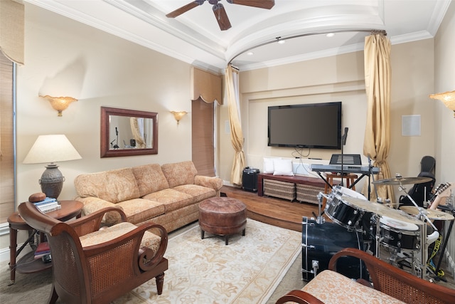 living room featuring wood-type flooring, ceiling fan, and ornamental molding