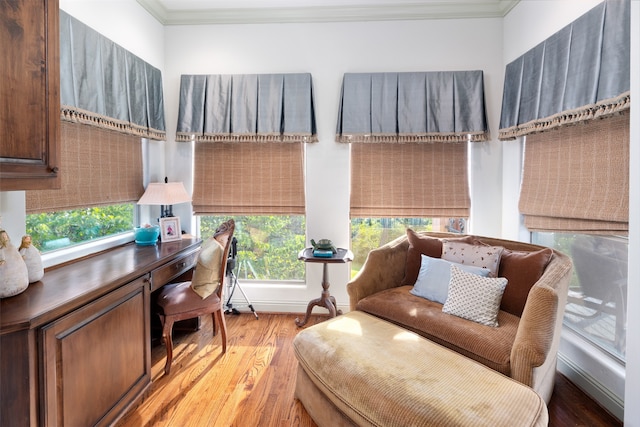 sitting room with light hardwood / wood-style floors and ornamental molding