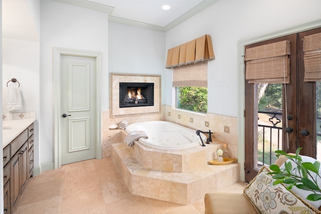 bathroom featuring tiled bath, crown molding, and vanity