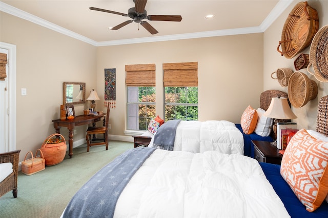 carpeted bedroom featuring ceiling fan and crown molding