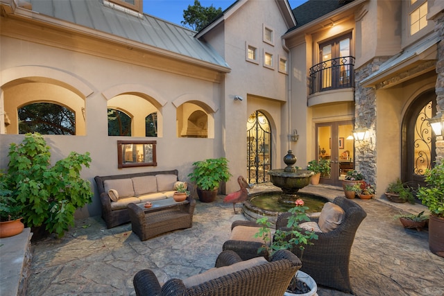 view of patio / terrace featuring outdoor lounge area, a balcony, and french doors