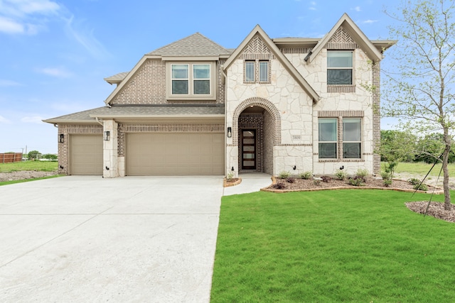 view of front of property featuring a garage and a front lawn