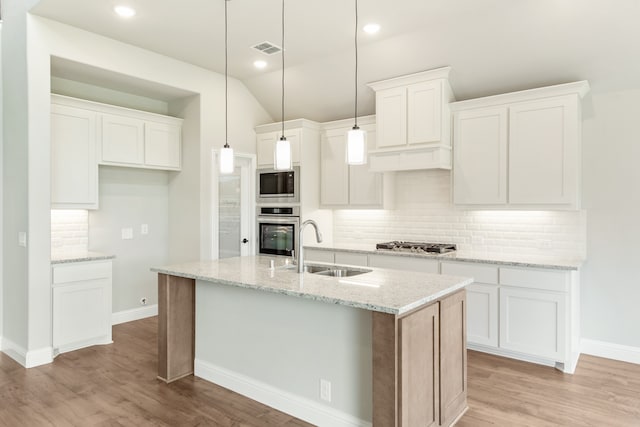 kitchen featuring backsplash, sink, stainless steel appliances, and white cabinetry