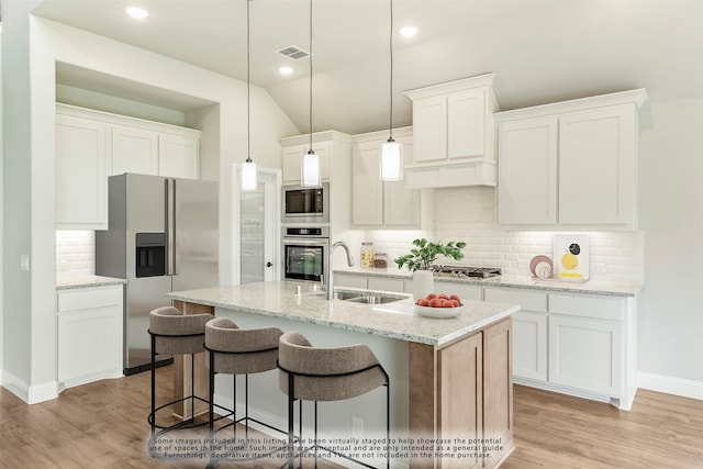 kitchen with stainless steel dishwasher, hardwood / wood-style floors, ceiling fan, and a fireplace