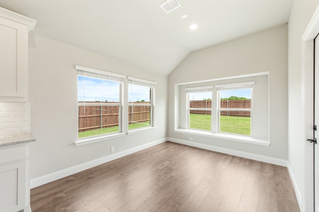 spare room with vaulted ceiling, ceiling fan, and carpet