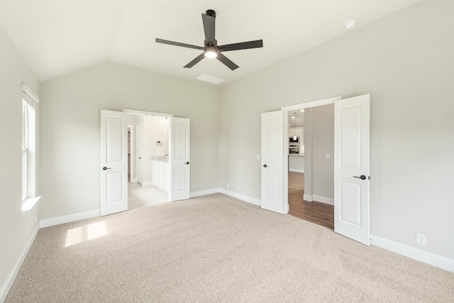 carpeted spare room featuring ceiling fan and a wealth of natural light