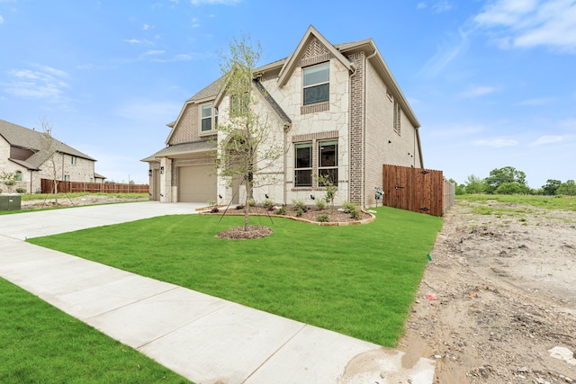 view of front of home featuring a front lawn and a garage