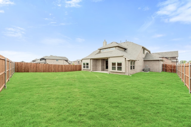 back of property featuring a yard and central AC unit