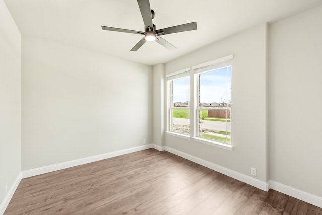 spare room featuring hardwood / wood-style flooring and ceiling fan