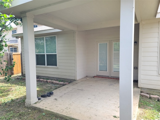 view of exterior entry featuring a patio area